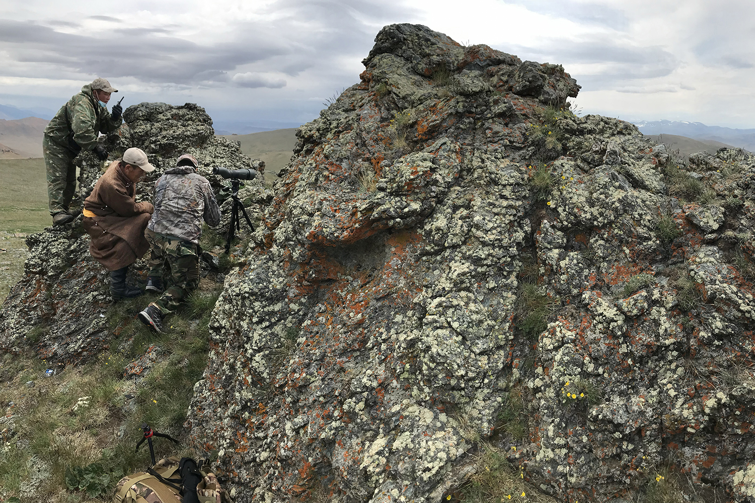 hunting spotters on rock outcrop