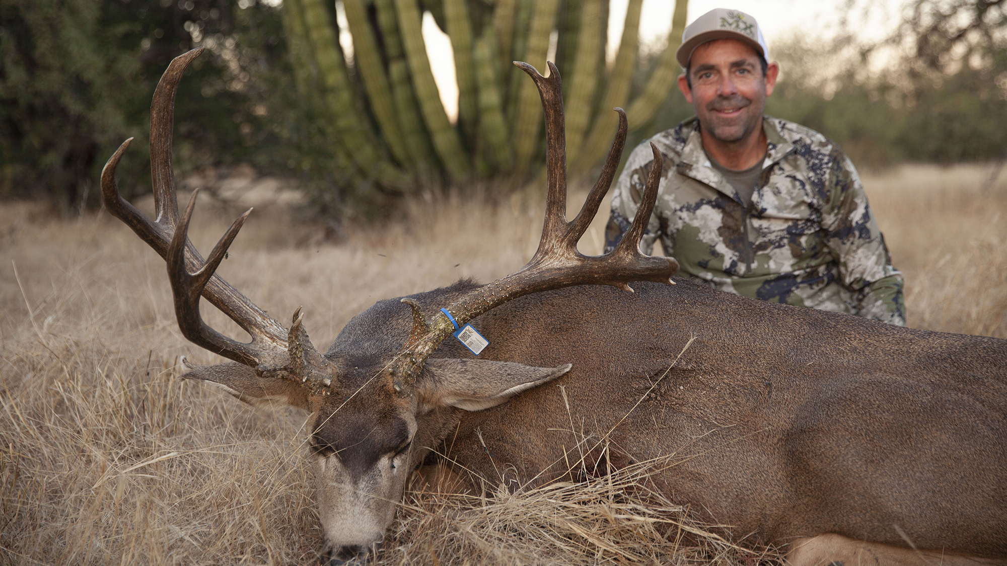 hunter with large mule deer