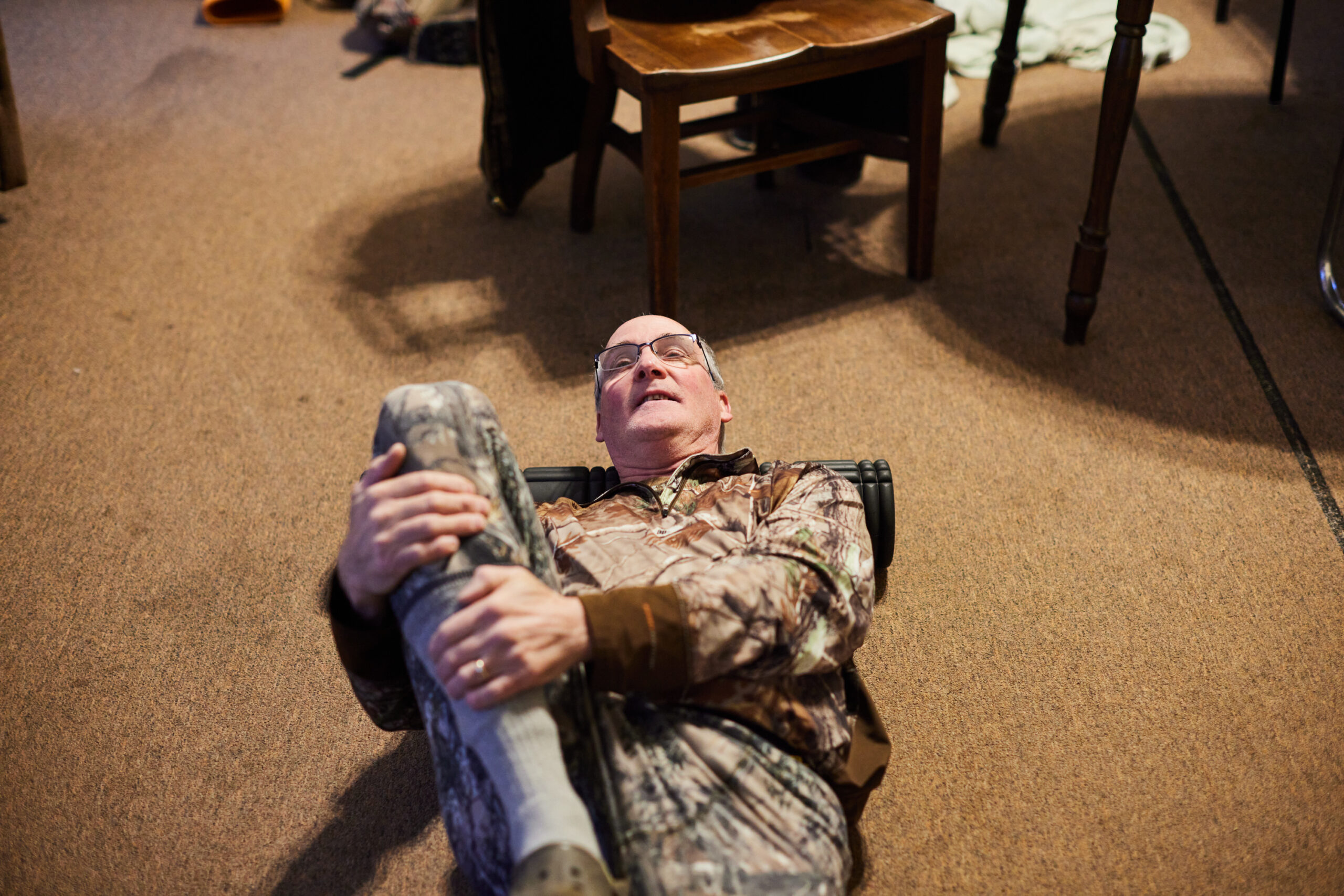 A hunter stretches on the floor