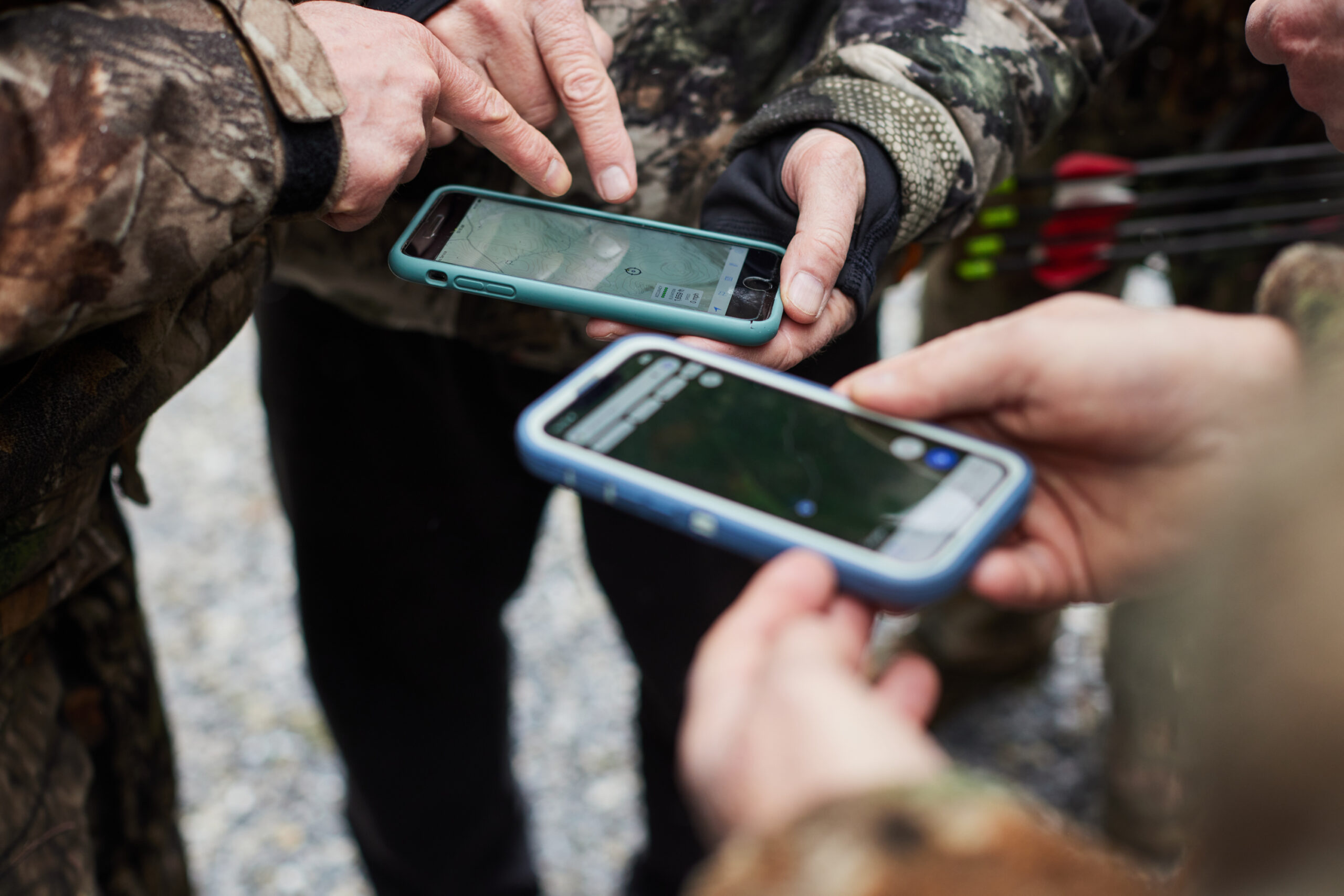 Hunters look at their phones while deciding where to hunt.