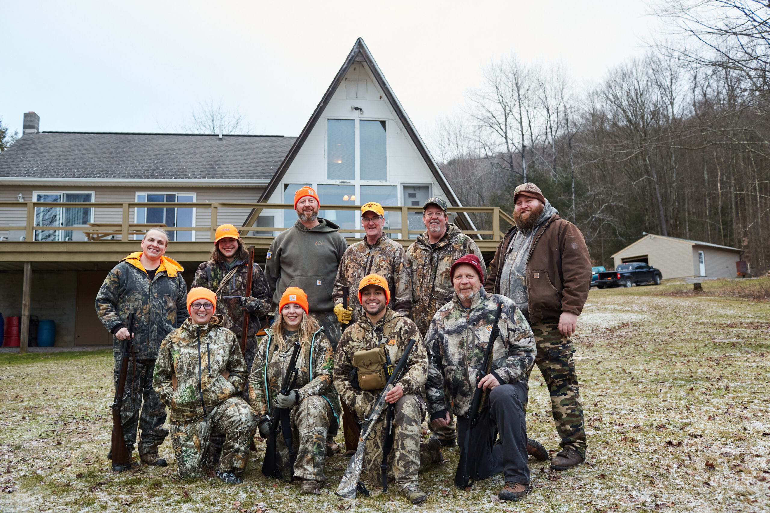 Posing for a camp bulletin-board photo. While this year’s deer drives didn’t produce any filled tags (for our crew), it helped keep the tradition of Pennsylvania flintlock hunting alive and well. Zac Clark (back row, far right) is our crew's outlier for flintlock success: He’s tagged 15 deer in 20 flintlock seasons. The hunt always fell during winter break in high school and college, when he was able to spend the most time in the woods. “I’ve killed more deer with my flintlock than any other weapon,” says Clark, 32. “I love hunting this time of year. I look forward to these three weeks all year, and once the season kicks off, I make the most of every second.” 

From left, front row: Whitney Strosser, Madalynn Talerico, the author, and Dean Severson. From left, back row: Austin Strosser, Brayden March, Dave Steele, Steve Waldman, Kurt Westbrook, and Clark. 