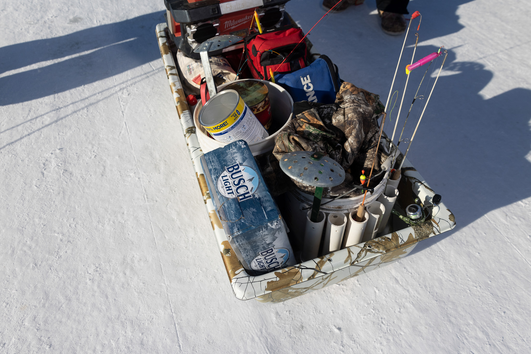 An ice fishing sled complete with busch light.