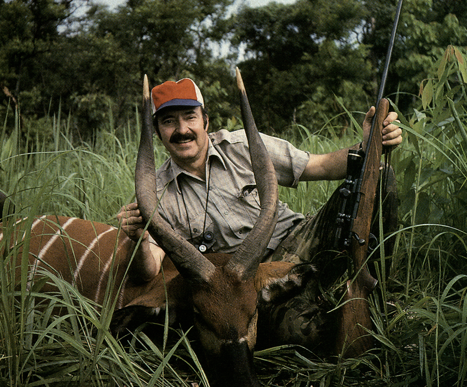 Jim Carmichel with rifle and African antelope