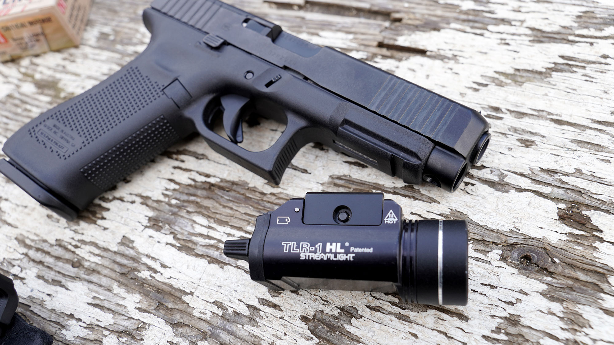 Streamlight TLR-1 weapon light and pistol on bench