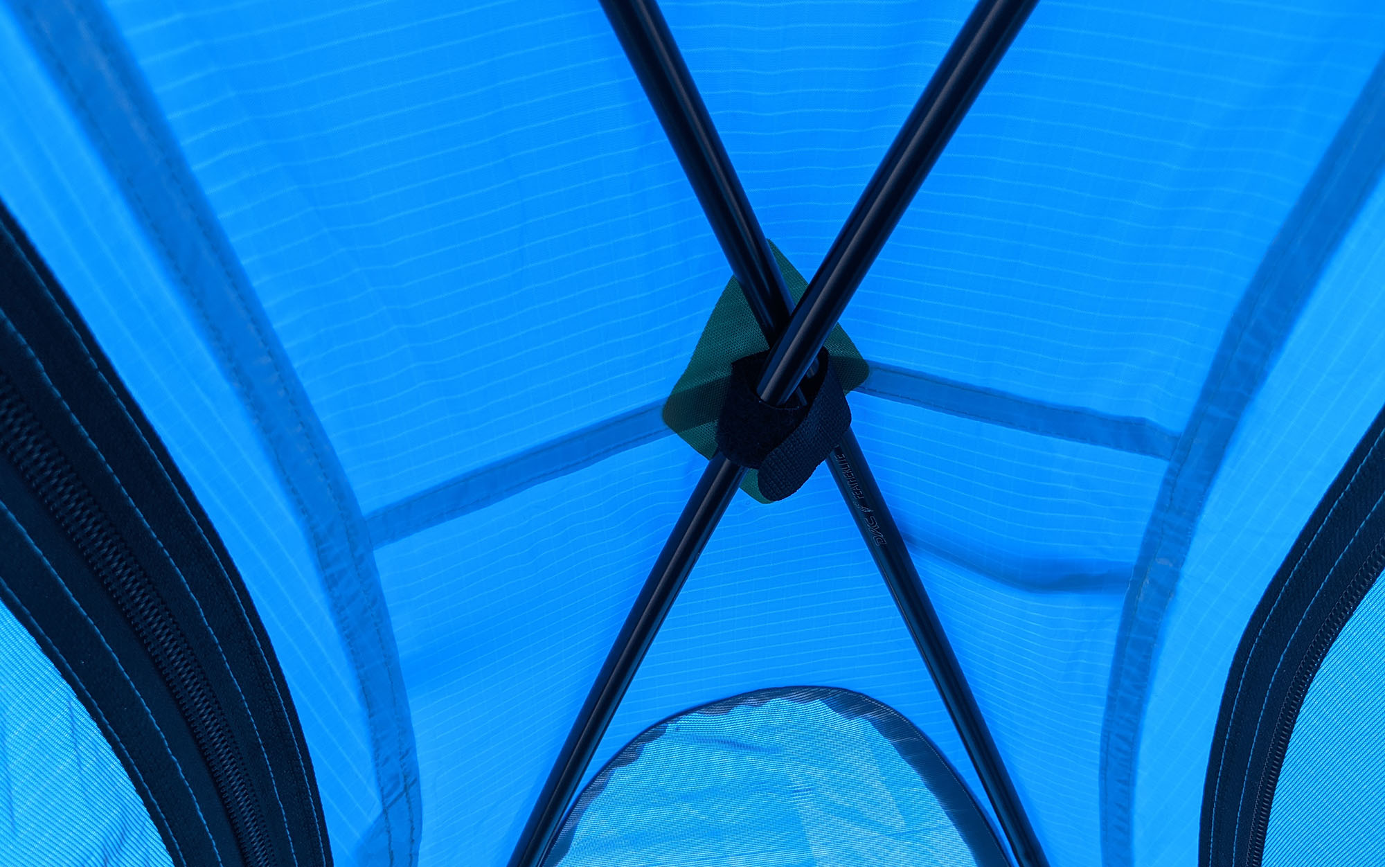 The crisscrossing poles of the Black Diamond Hilight are secured to the inside of tent using velcro straps.