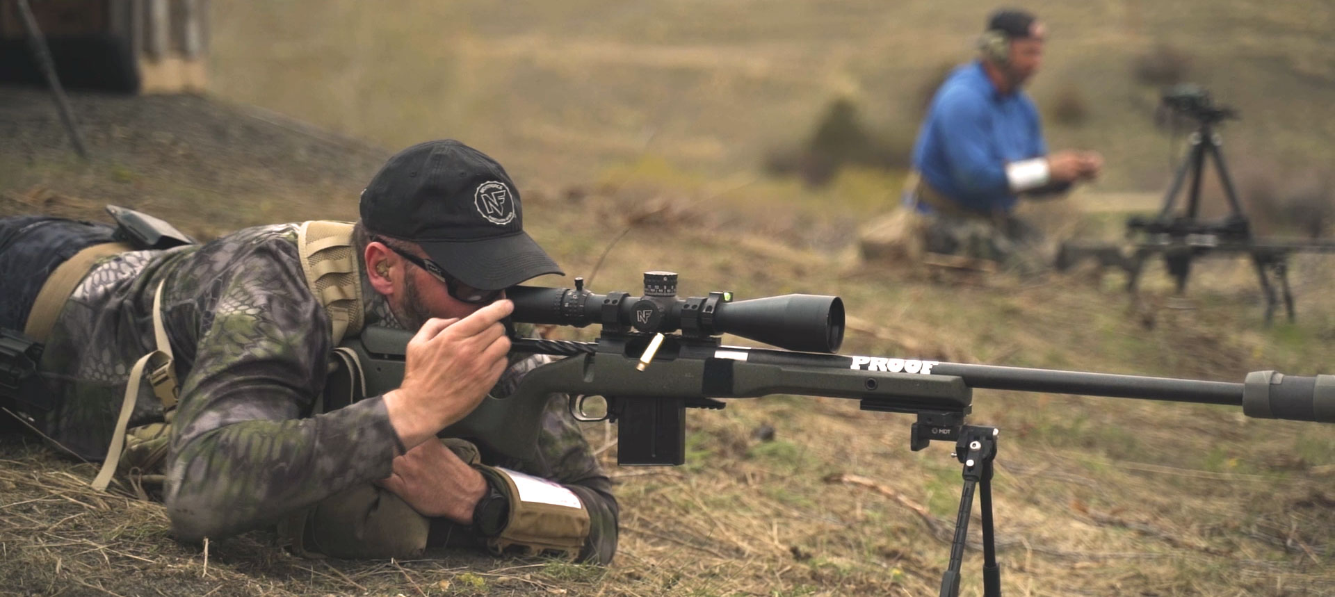 Shooter running a Proof Research rifle during a team sniper competition drill