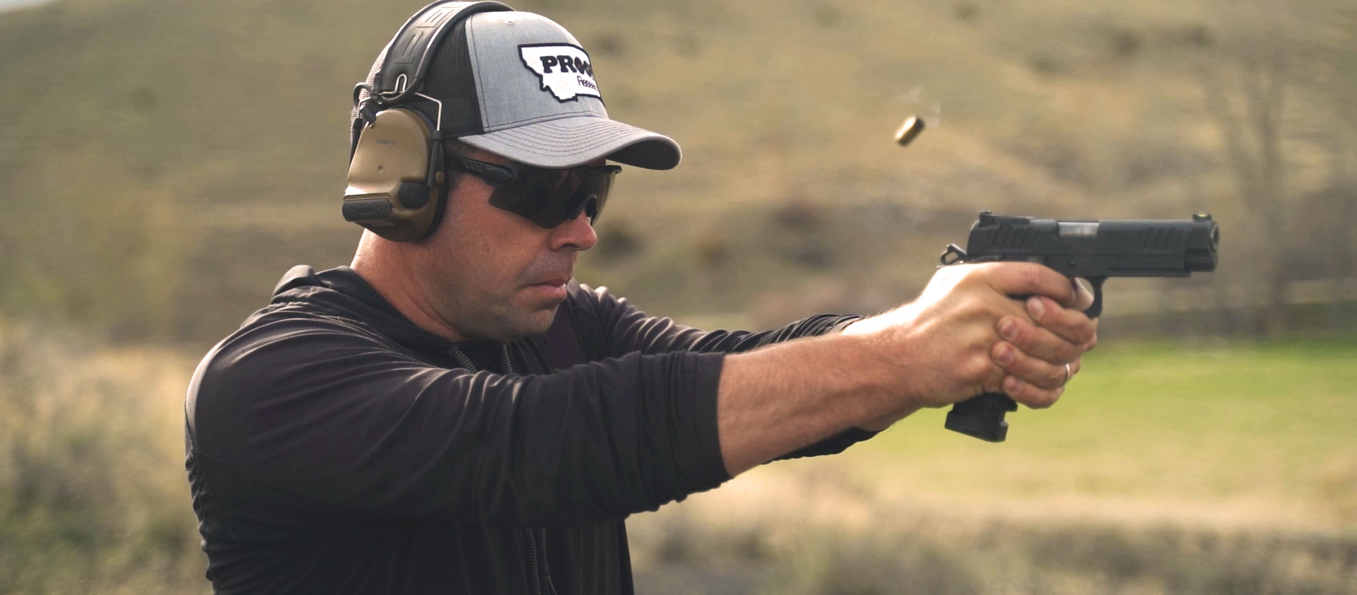 Sean Murphy shooting a 9mm pistol with brass in the air