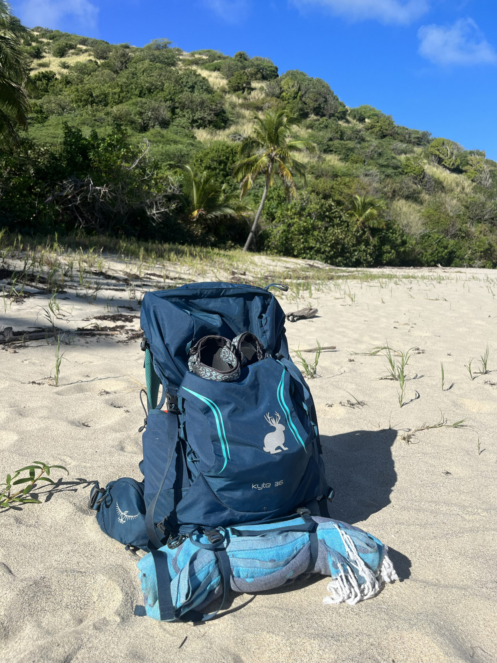 I stored my wet and sandy towel on the outside of my pack to keep the inside clean for snacks and clothes on the beach.