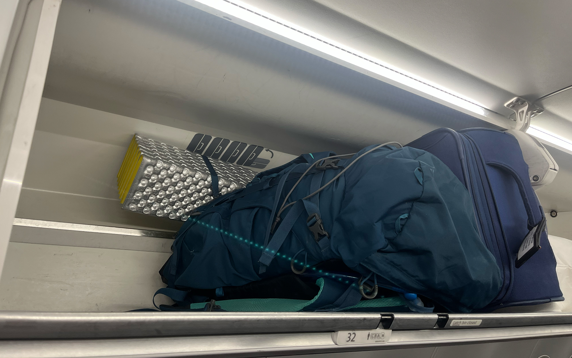 The Osprey Kyte fits in the overhead bin even with a sleeping pad attached to the bottom.
