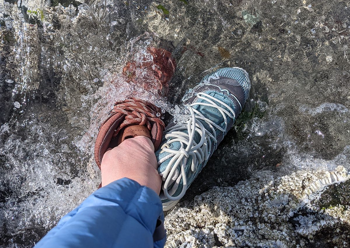Two of the best waterproof hiking boots sit in a stream.