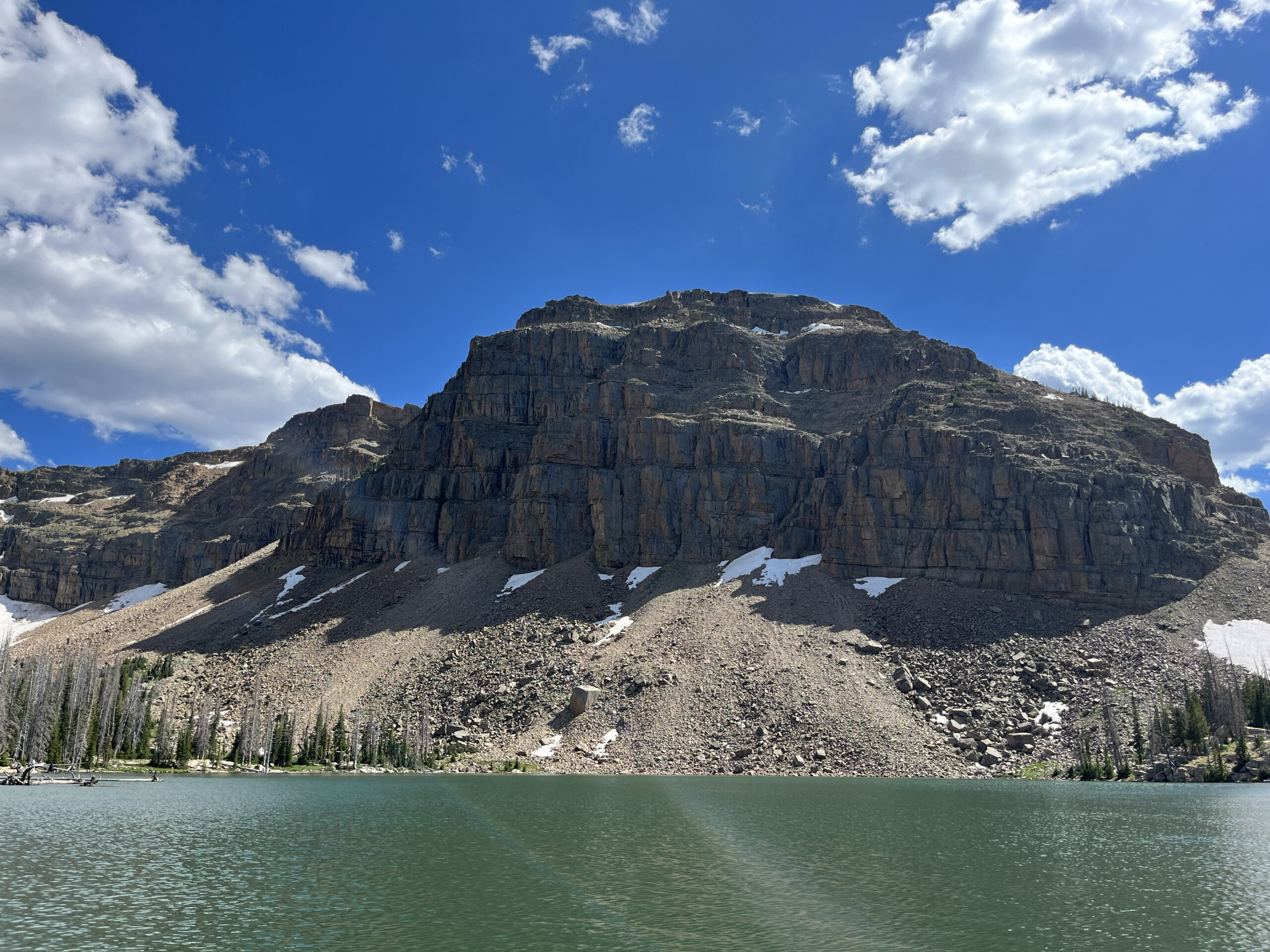 A mountain sits across a lake.