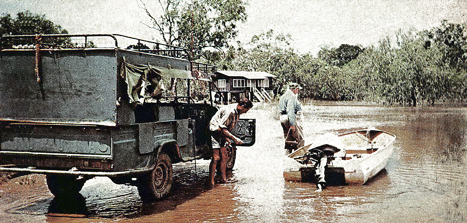 australia flooded area, hunters move into small boat from truck