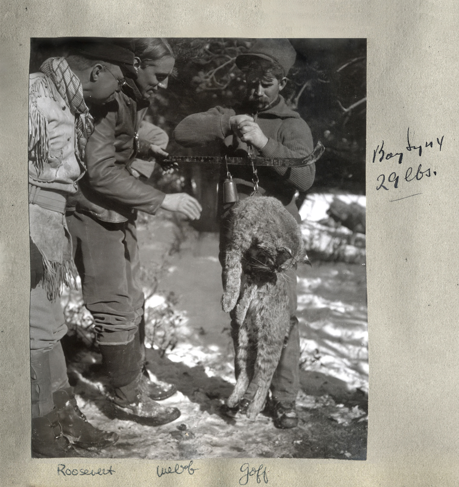old photograph of TR and two other hunters with a dead wild cat
