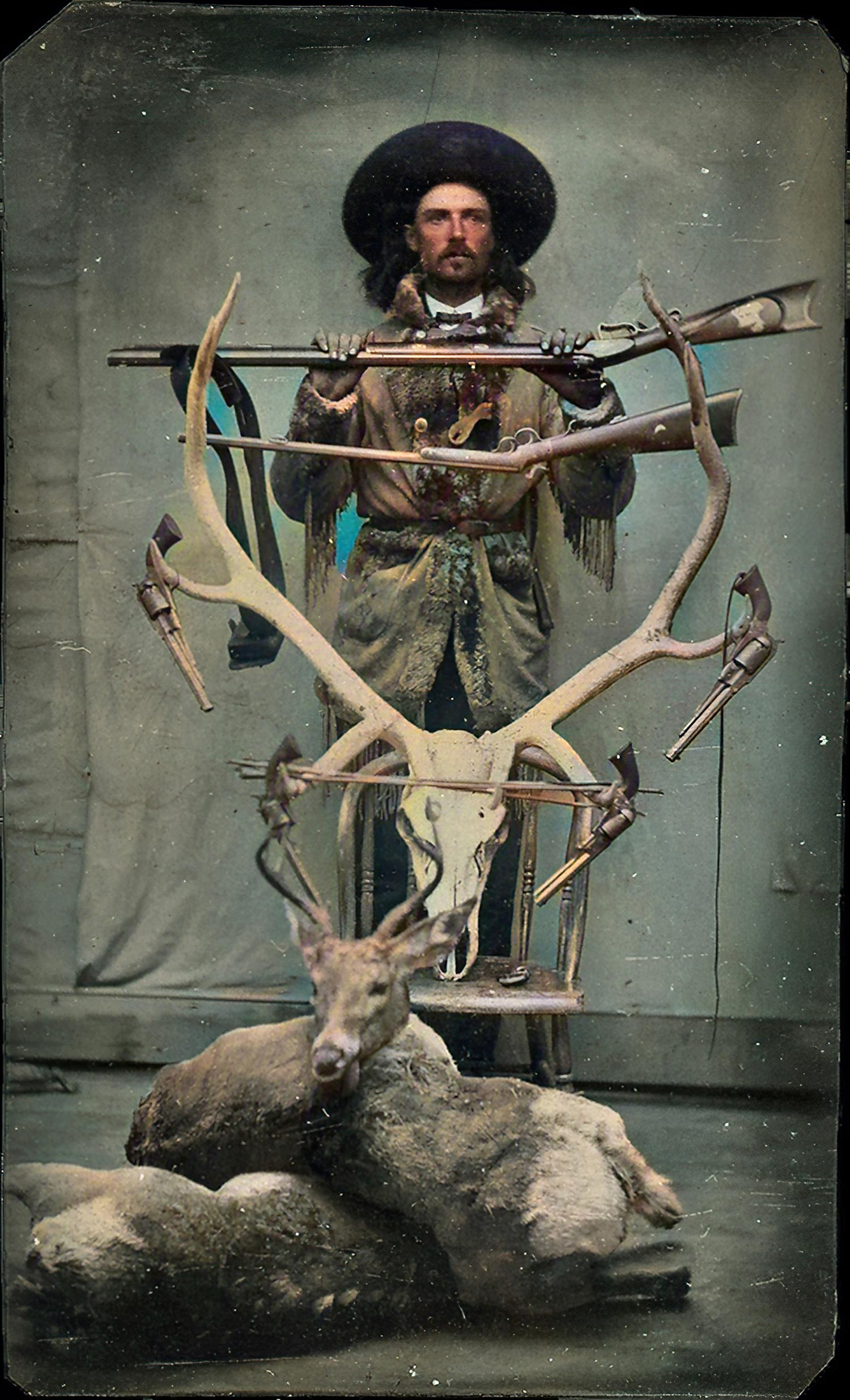 Buffalo Bill Cody photographed with an elk skull and deer.