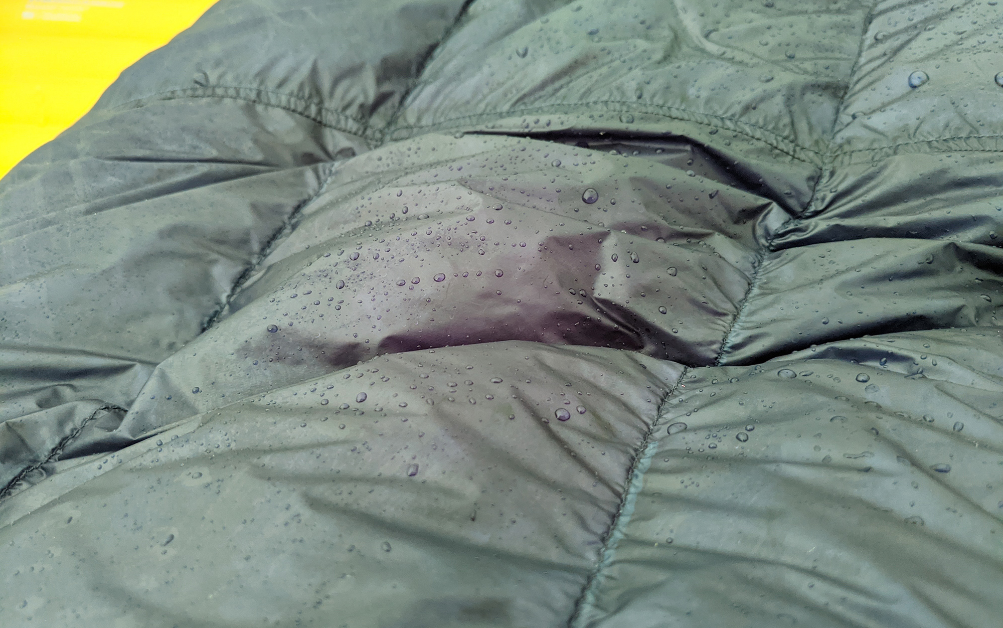Dew drops sit on one of the best ultralight quilts.