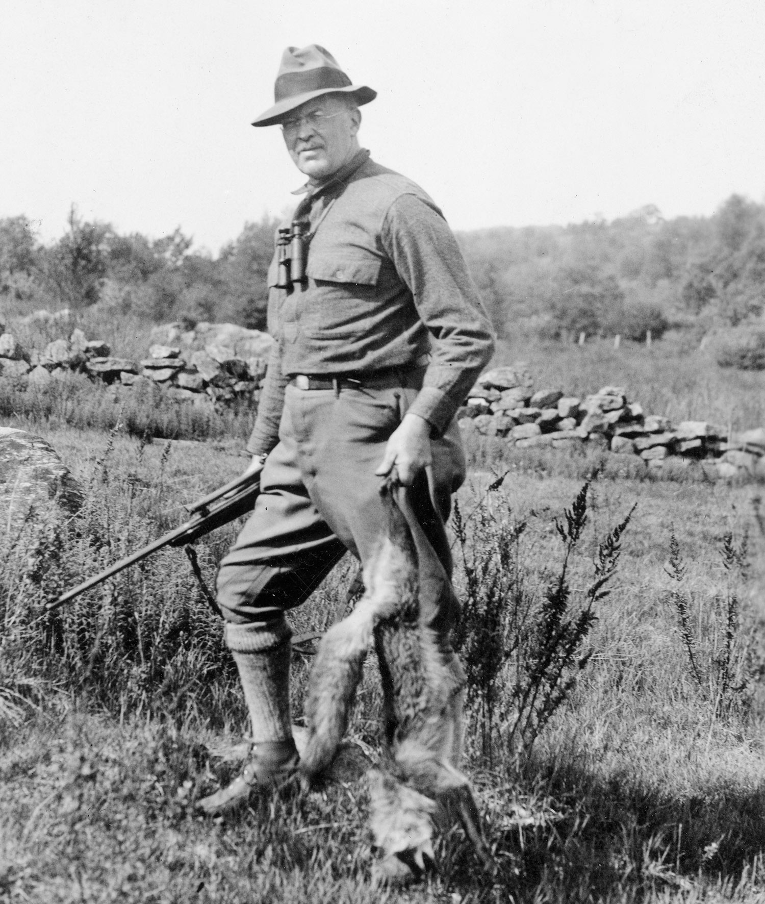 Colonel Townsend Whelen standing in a field in a black and white photo
