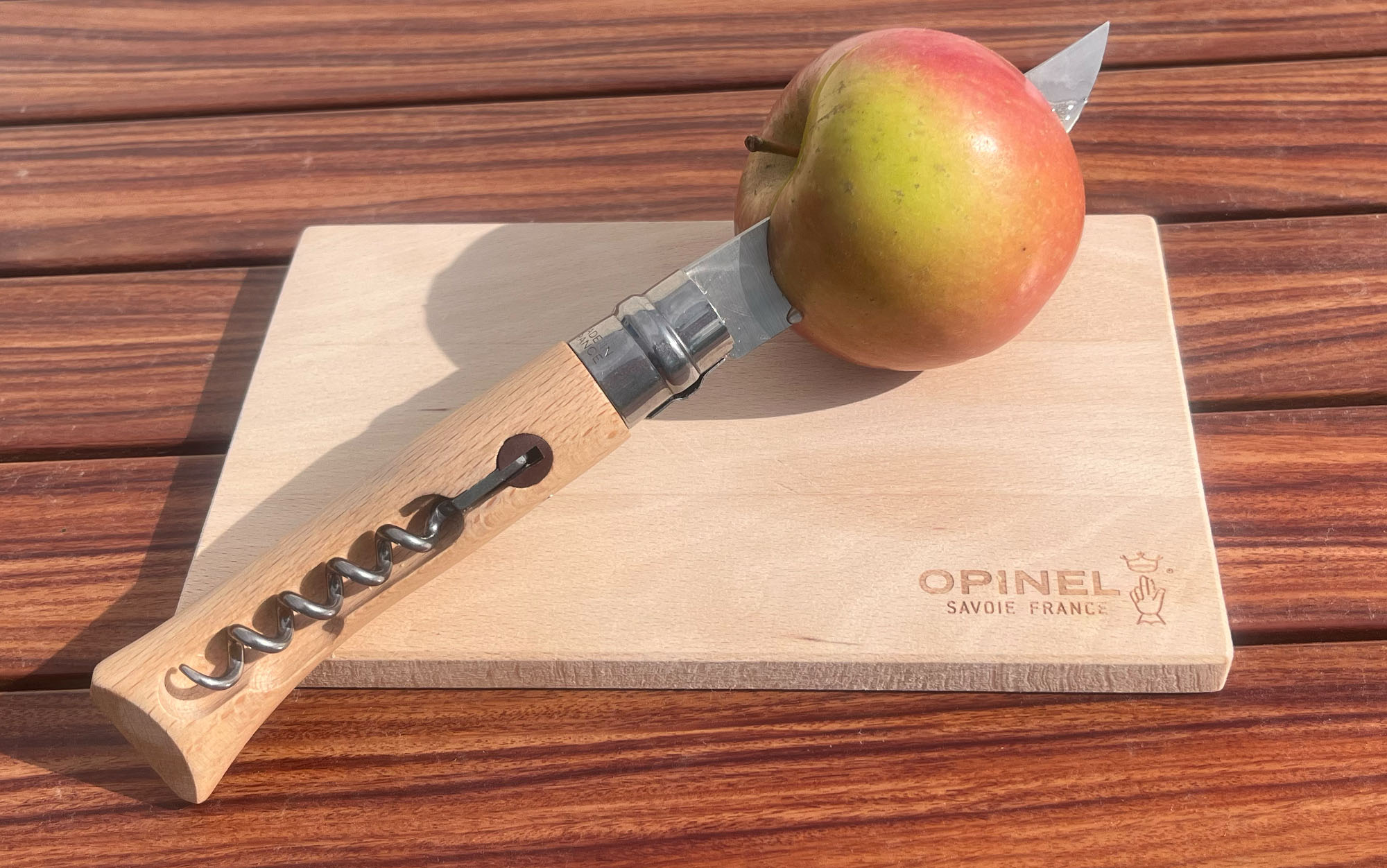 Opinel knife cuts apple.