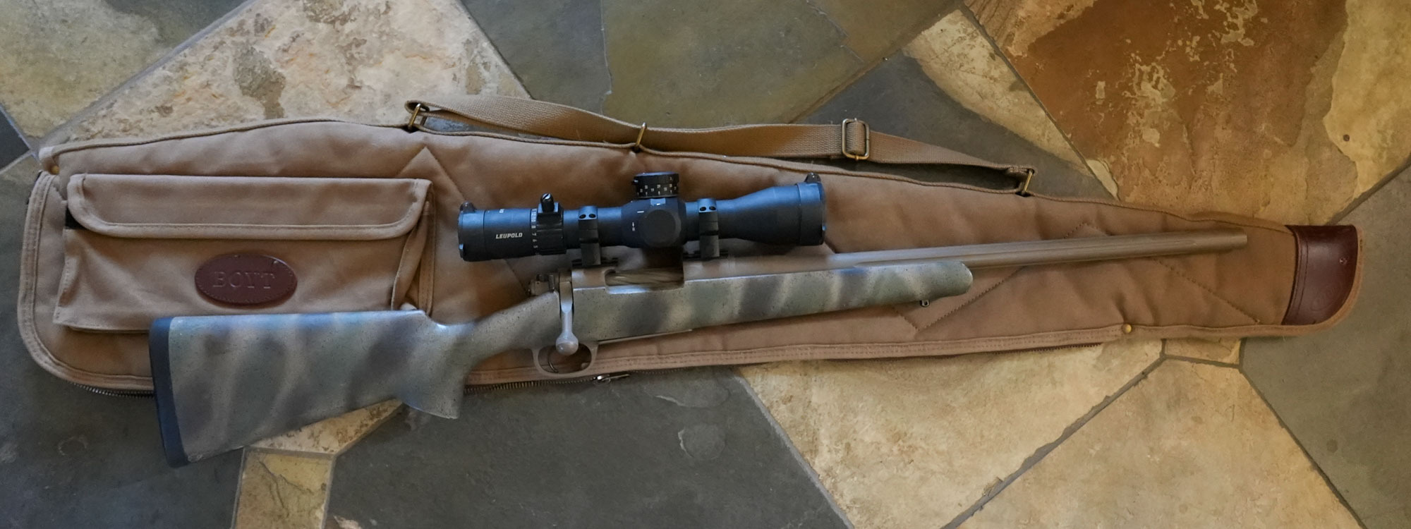 A rifle sits on the Boyt Signature Scoped Rifle Case.