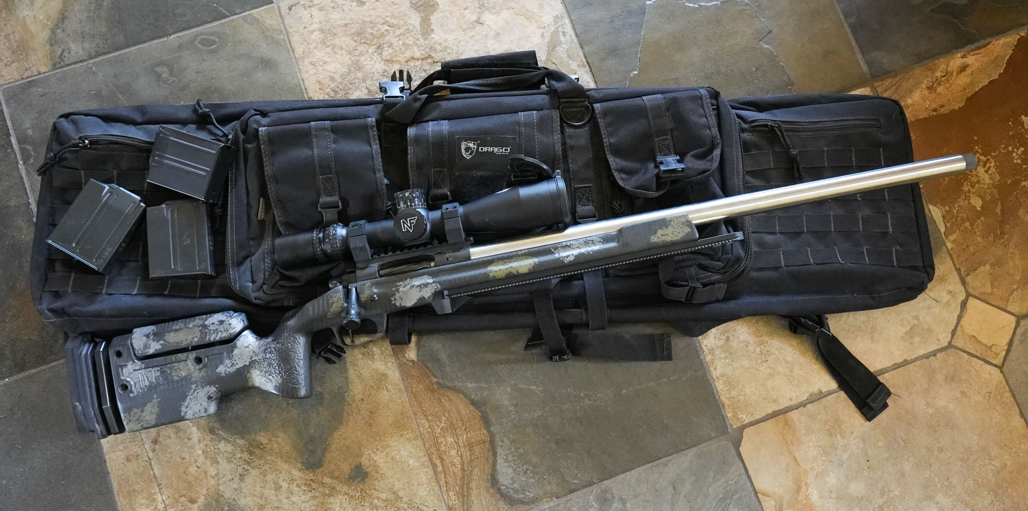 A rifle sits on the Draco rifle case.