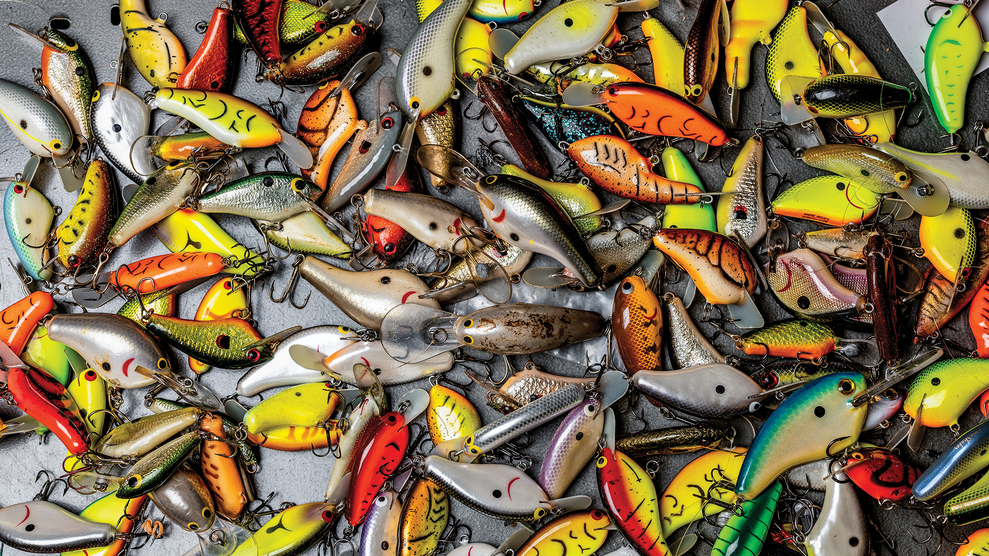 big pile of colorful crankbaits laid out on metallic background