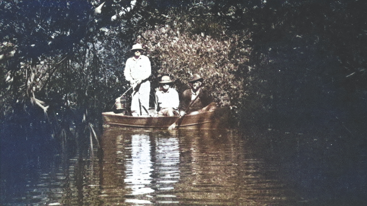 Three men fishing in a boat in the everglades.