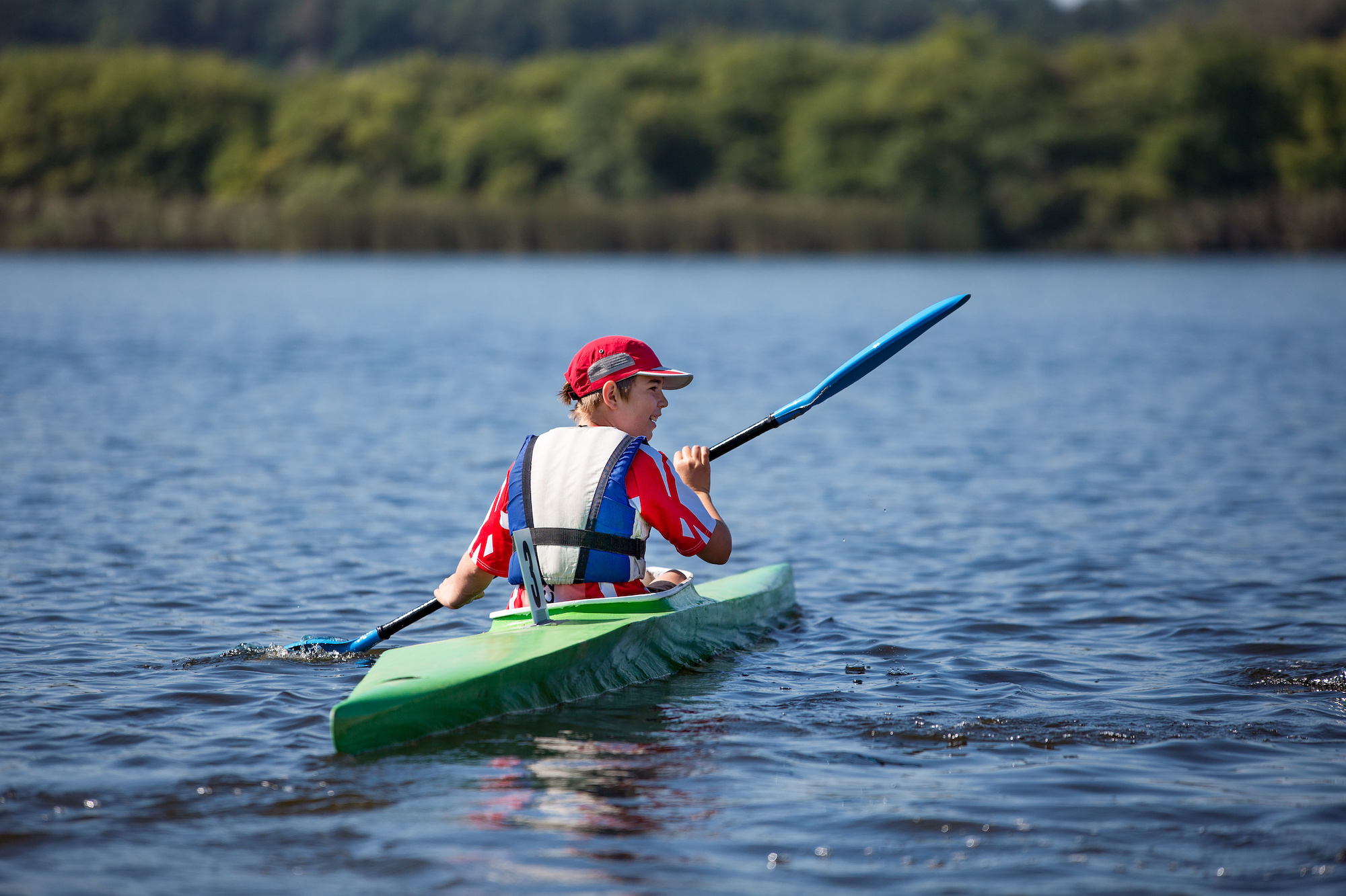 what to wear when kayaking boy paddling on lake