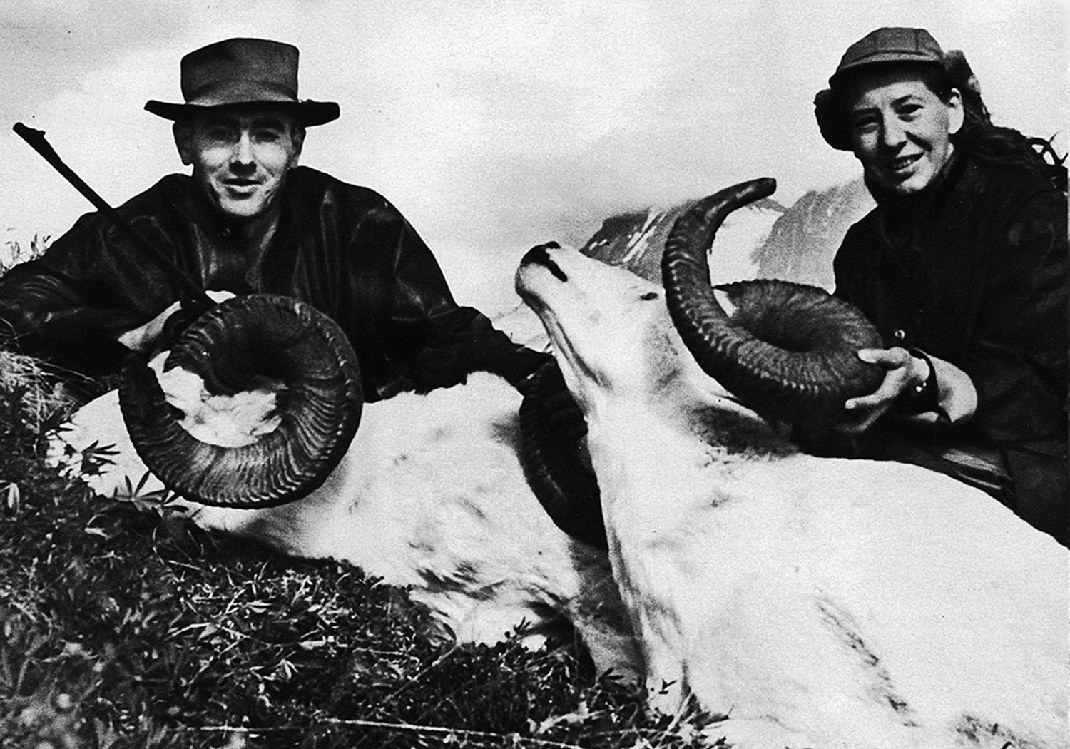 Two hunters pose with two trophy-book rams