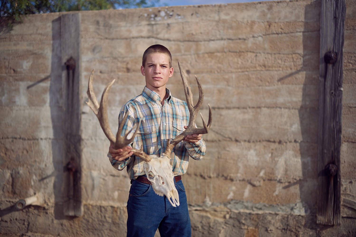 young man holds mule deer euro mount