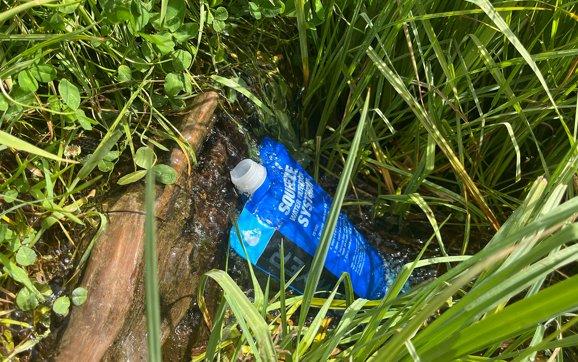 Filling up my water filter bag from a natural spring.