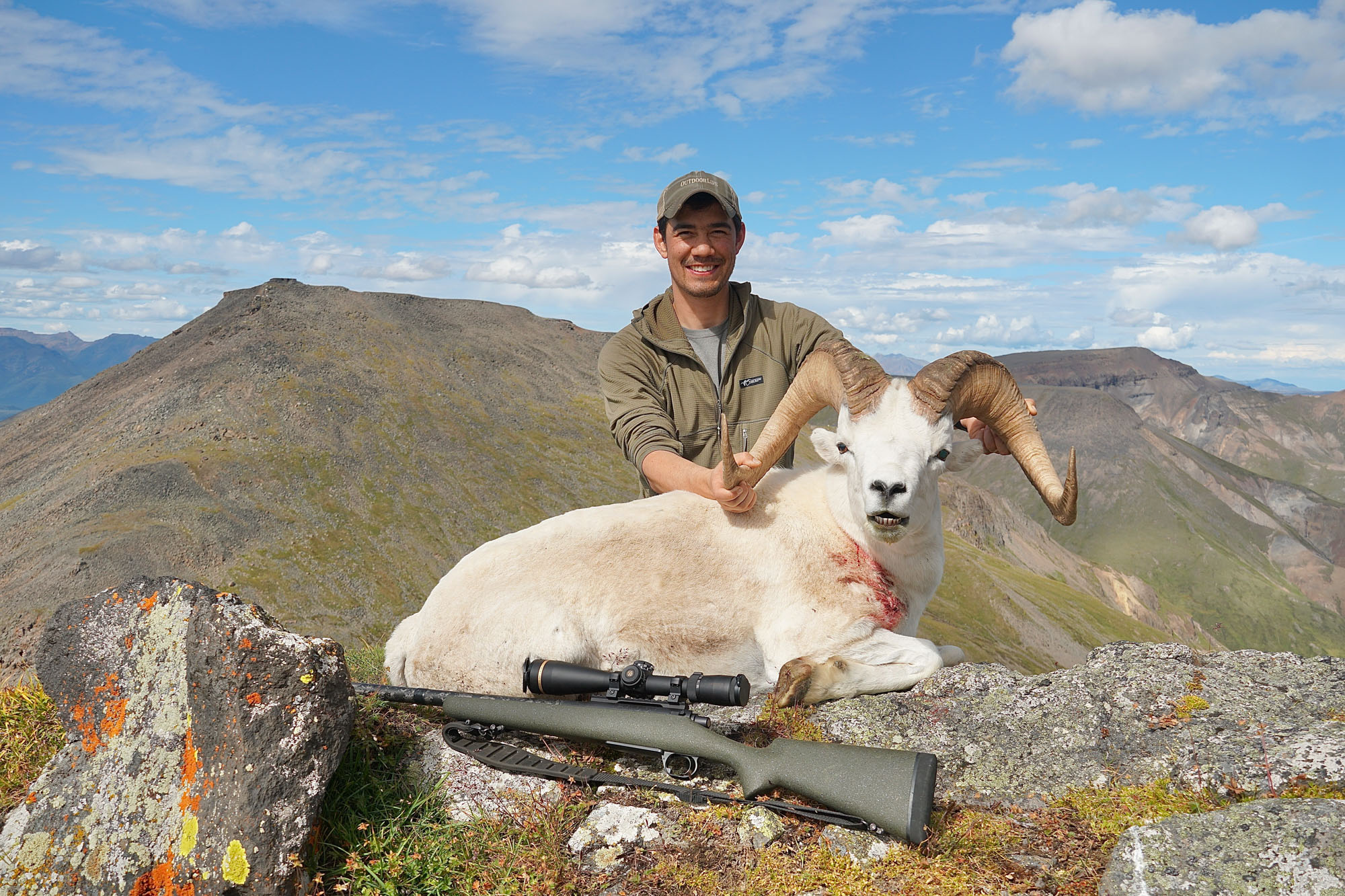 Alex Robinson with a 6.5 PRC rifle from Proof Research on a Dall Sheep hunt