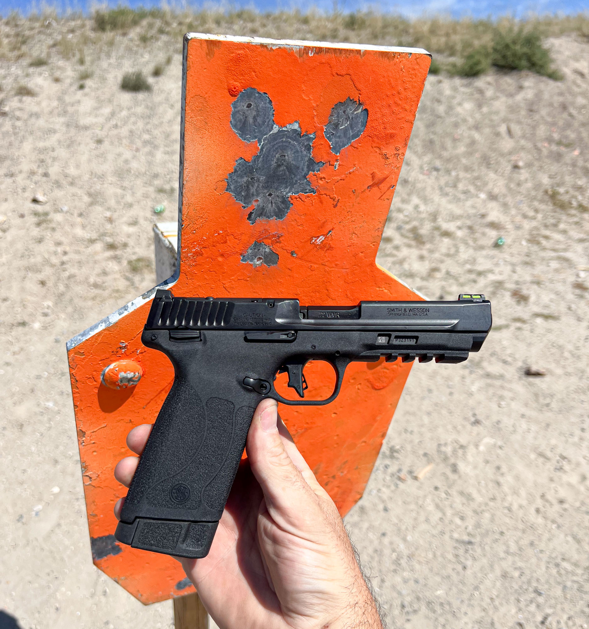 Smith & Wesson M&P 22 Magnum in front of target at range