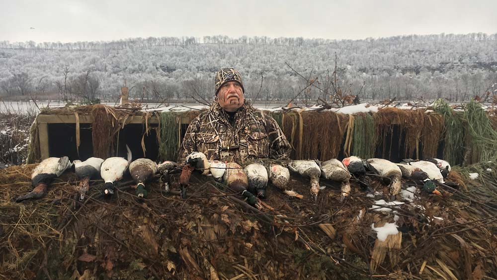 waterfowl hunter with a brace of ducks