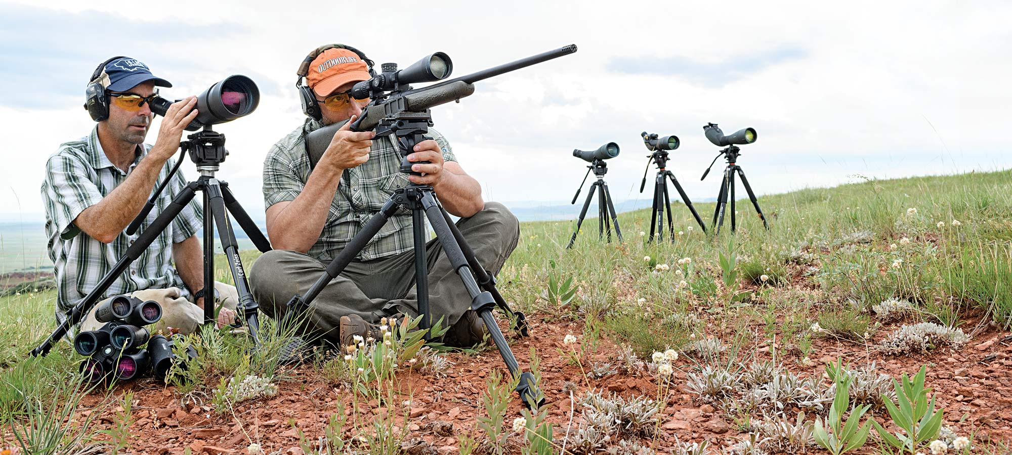two hunters testing optics scopes and binoculars