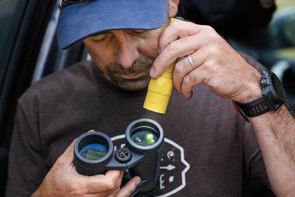 hunter checking binoculars