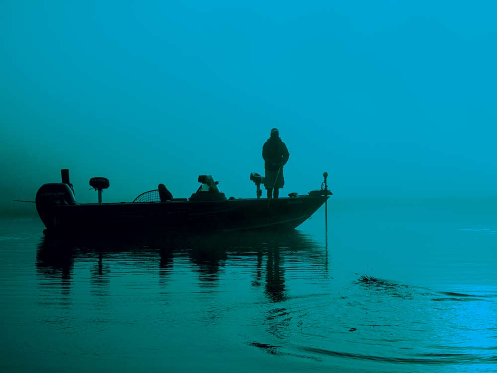 lone angler on a boat fishing for muskie