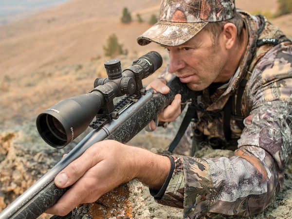a hunter aiming a rifle 
