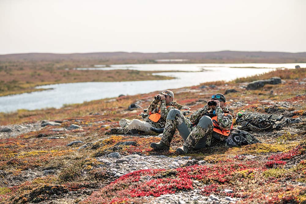 two hunters surveying canadian tundra