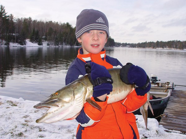 kid with shore-caught muskie