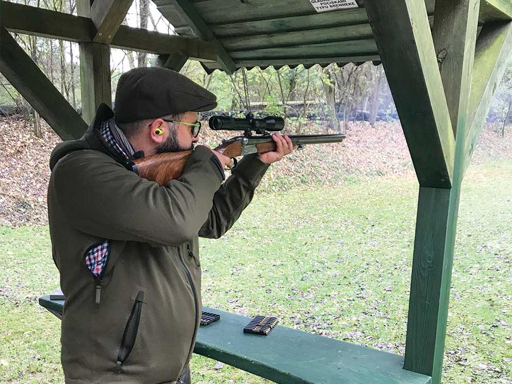 hunter aiming rifle at a shooting range
