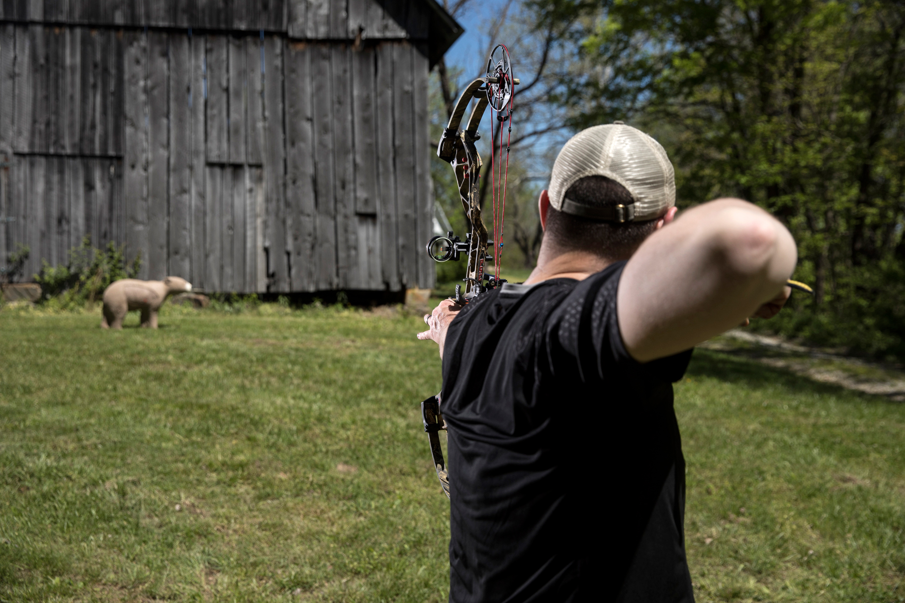 an archer shoots a 3D bear target