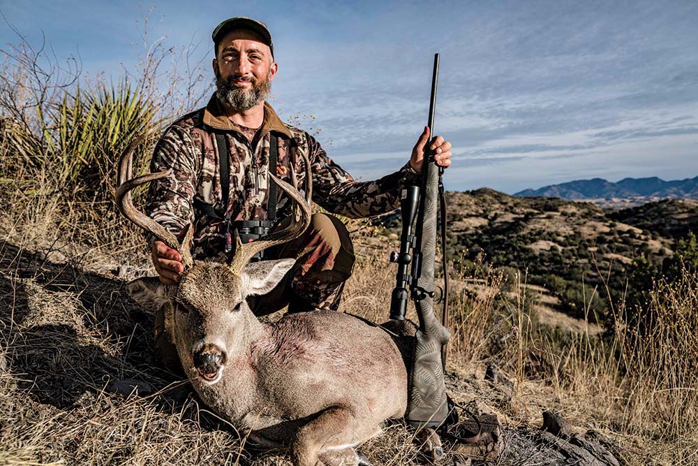 john b. snow posing next to ocotillo buck