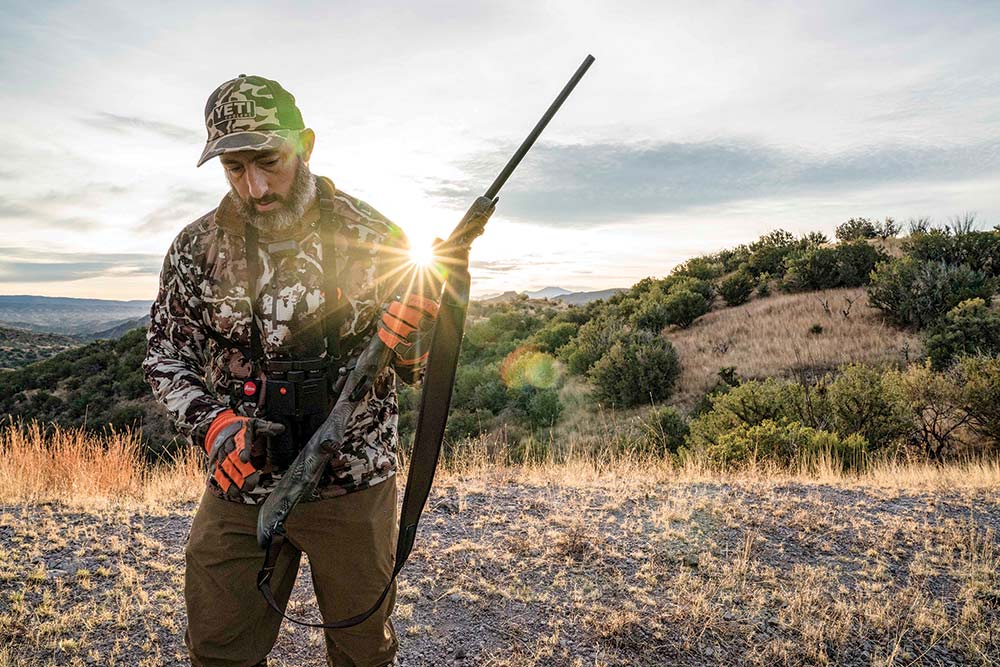 hunter checking rifle while hunting