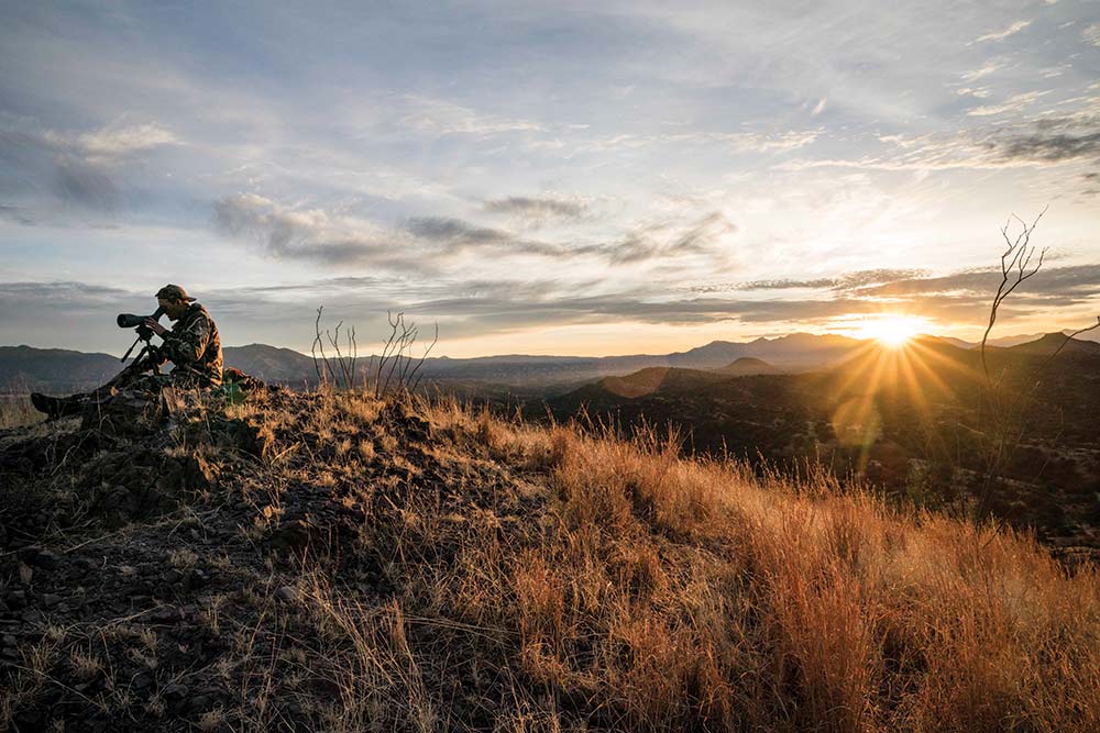 sun cresting a mountain hillside