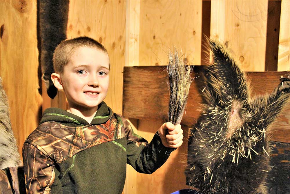 kid holding porcupine quills