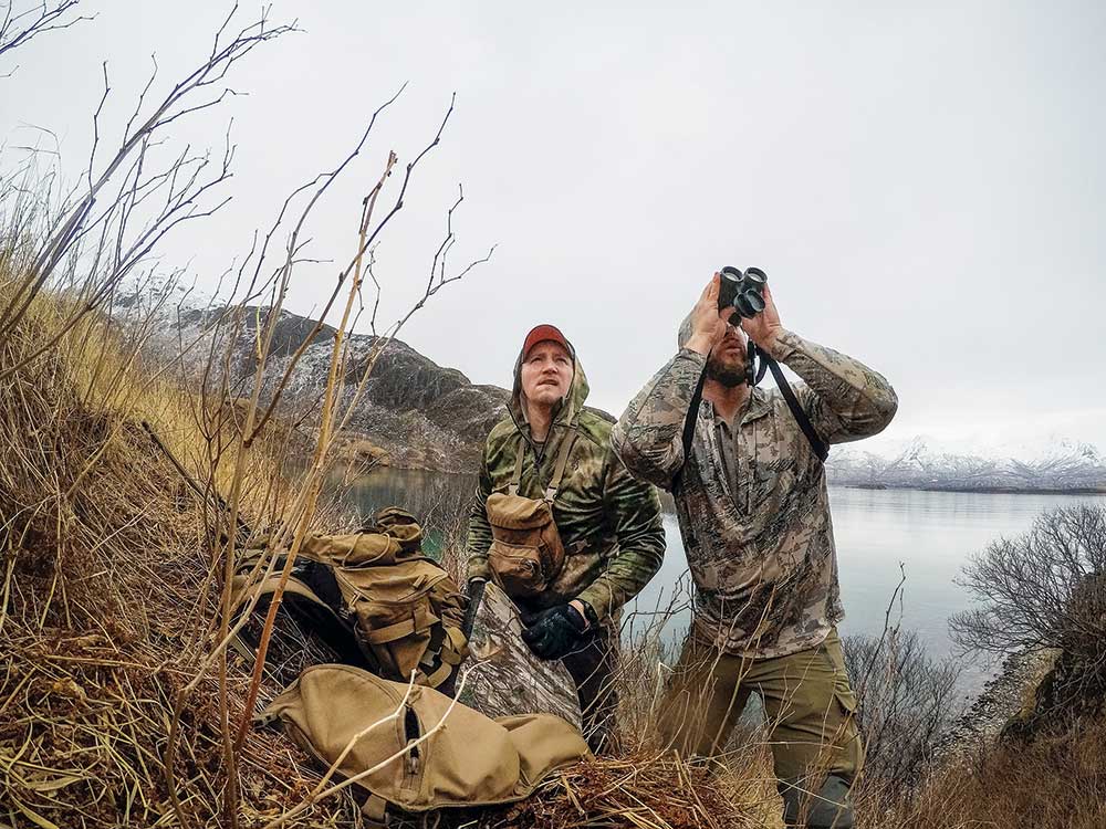 two hunters using binoculars