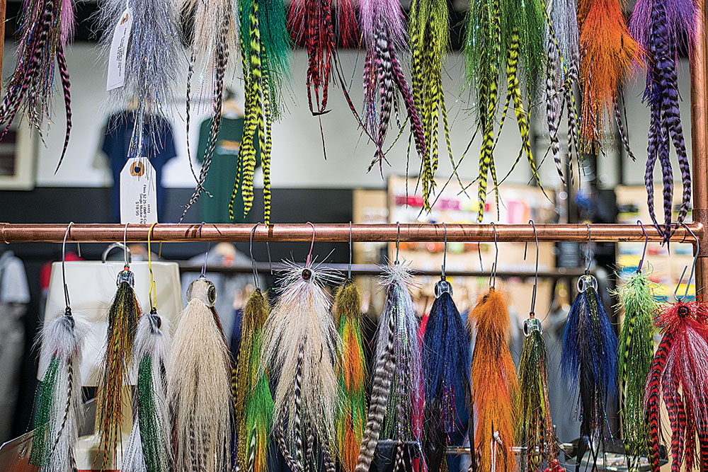 a large selection of custom muskie fly lures on a rack