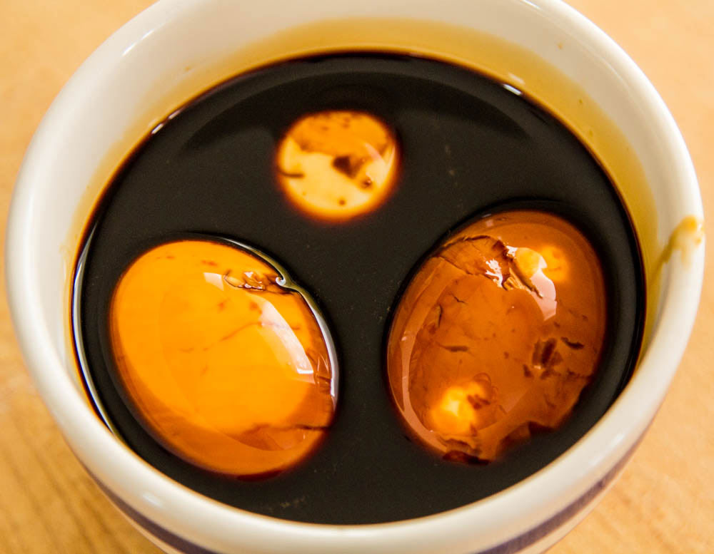 hard-boiled eggs marinating in soy sauce and mirin