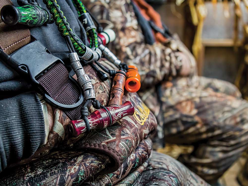 a necklace of duck calls and tags