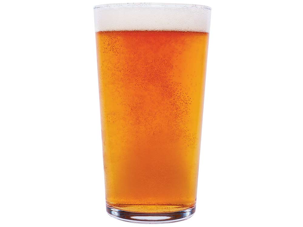 a glass full of bubbling ipa beer