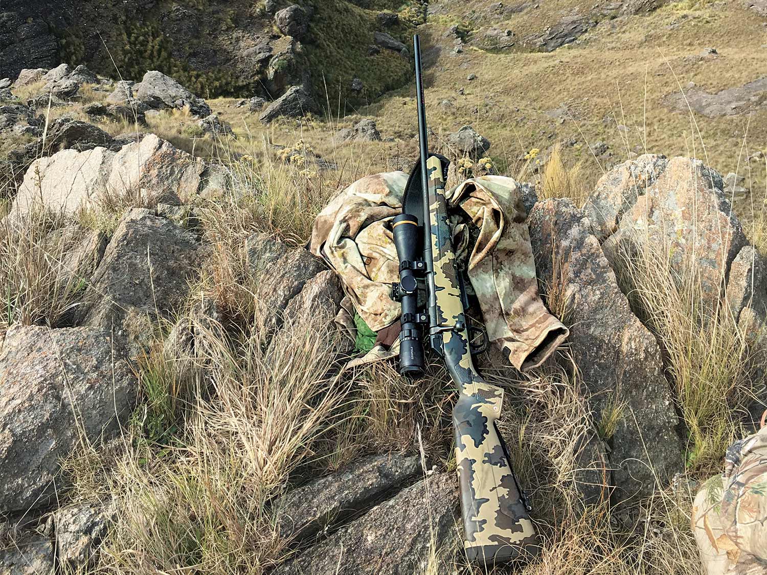 a Winchester xpr rifle leaning against rocks